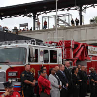 <p>First responders and others from the city of Paterson watch the city&#x27;s 9/11 memorial service.</p>