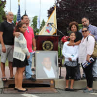 <p>The family of Kenneth Lira, who was on the 107th floor of South tower of the World Trade Center on September 11, 2001, pose with his portrait at a ceremony memorializing that day&#x27;s events.</p>