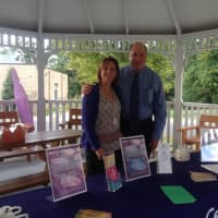 <p>Beth Andrews, volunteer and intern coordinator with the Center for Family Justice, and Mark Antonini, CFO and COO of the Center for Family Justice, pause while setting up for the domestic violence awareness vigil in Easton on Monday, Oct. 3.</p>