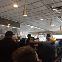 <p>Diners rush out away from the sprinkler at BLD Diner in Larchmont.</p>