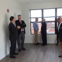 <p>Tom Rich discusses the apartments available in the SONO Pearl with people who took a tour of the building Thursday, Oct. 13, 2016.</p>