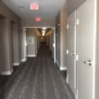 <p>Looking closely down the hallway of one floor in the SoNo Pearl, you can spot the lighted doorknobs of the apartment doors, a convenient feature for residents.</p>