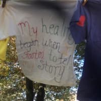 <p>One of the scores of T-shirts decorated by survivors of abuse hangs near Trumbull Library as part of The Clothesline Project.</p>