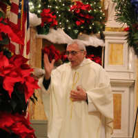 <p>Rev. Peter T. Sticco blesses candles.</p>