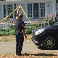 <p>An officer lets a car pull into the Lordship neighborhood in Stratford where a shooting occurred early Wednesday morning.</p>