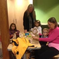 <p>William Salvatore, 3, of Fairfield, and his grandmother, Ellen Nelly, inspect the paper bag puppet he created at Stepping Stones&#x27;s Jumpstart Read for the Record program in Norwalk as other participants finish up their crafts.</p>