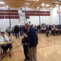<p>Voters of all ages spread out in the gym at Danbury High School to vote on Tuesday.</p>