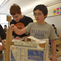 <p>The students used boxes of different shapes, aluminum foil and straws to add detail to their buildings.</p>