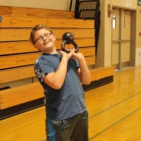 <p>An Irvington Middle School student working out with a kettlebell during fitness boot camp.</p>