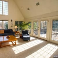 <p>High ceilings and windows in the living room area.</p>
