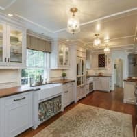 <p>The kitchen is modern and features custom cabinetry.</p>