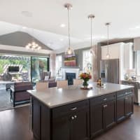 <p>The gourmet kitchen opens up into the living room with easy access to an outdoor patio.</p>
