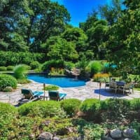 <p>The backyard pool features a waterfall and wonderful view.</p>