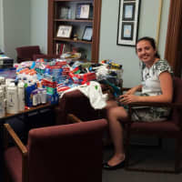 <p>Intern Nicolette Smith sorts the many hygiene items collected in the drive.</p>