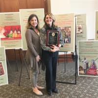 <p>Fox Lane High School’s Raffaella Pirone holds a plaque she received as winner of a national teaching award.</p>