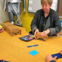 <p>Marcia Daley-Savo, a humanities teacher at John Jay Middle School, assembles a Google Cardboard device.</p>
