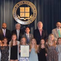 <p>Ursuline School&#x27;s Junior Varsity Cheerleading Team holding commendation certificate with New Rochelle City Council.</p>