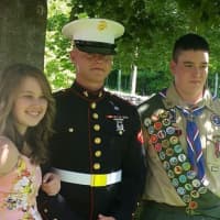 <p>Marine Jack Foley, center, with his sister Bridget and friend Billy Barlow at the Amawalk Firehouse.</p>