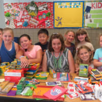 <p>Janet Singer from the DCF in Bridgeport and Royle students with the school supplies they collected</p>