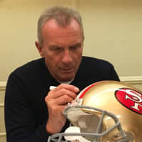 <p>Legendary San Francisco 49ers quarterback Joe Montana signs a helmet for a fan.</p>