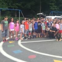 <p>A Ramapo officer poses with Viola Elementary School students following his K-9 demonstration on Thursday.</p>
