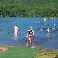 <p>Kara Wilczynski, 12,  emerges from the water during her first triathlon.</p>