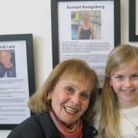 <p>Kendall Konigsberg with her grandmother at the Rye YMCA. 
They are standing in front of her story, part of the 2015 exhibit on display through Feb. 15. Members of the public are welcome to stop by to view the stories at the YMCA at 21 Locust Ave.</p>