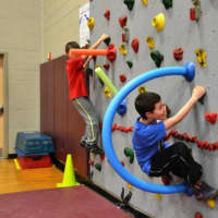 <p>Kenisco School students rock-climb for the school&#x27;s annual Jump Rope for Heart event.</p>