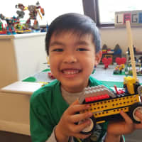 <p>Wynn Petchor shows off his Lego creation.</p>