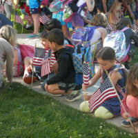 <p>Students of Lincoln School set flags along Montross Avenue for Flag Day.</p>