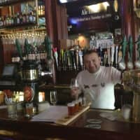 <p>A bartender at the Lazy Boy Saloon in White Plains prepares a beer flight.</p>