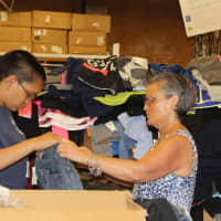 <p>An Ossining High School Life Skills student unpacks merchandise at a TJ Maxx store.</p>