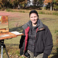 <p>Liron Sissman painting on Bedford Road in Bedford, N.Y. Her work is on exhibit at the Pomona Cultural Center. </p>