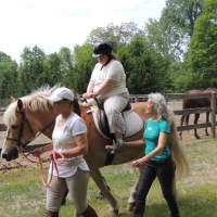 <p>Lisa Griffin of New Canaan learning to ride</p>