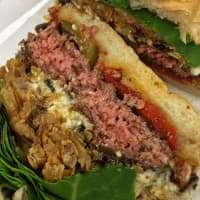 <p>Burgers are piled high at Little Pub.</p>