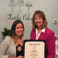 <p>Lovely Cakes owner/chef Renata Papadopoulos, left, with a citation given to her by state Rep. Laura Hoydick on the occasion of Lovely Cakes&#x27; grand opening Nov. 7.</p>