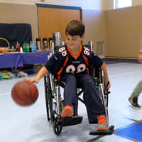 <p>Meadow Pond Elementary School student learns what it would be like to play basketball in a wheelchair during Differences Day.</p>