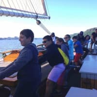 <p>Irvington students help crew members haul on the lines as they sail the Hudson River aboard the sloop Clearwater.</p>