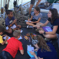 <p>Irvington students, and a crew member, gather on the deck of the sloop Clearwater to learn about the Hudson River firsthand.</p>