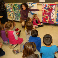 <p>Putnam Valley kindergarten teacher Dorothy French helps students evaluate their marble projects.</p>