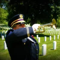 <p>Bugler Dani Masterson of Wappingers Falls has played Taps at thousands of ceremonies, most of them funerals for veterans. Shown playing at Arlington National Cemetery, she was recently recognized by the Exchange Club of Southern Dutchess.</p>