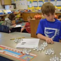 <p>A third-grader at Bronxville Elementary School uses a visual hands-on approach to solving a math problem, which is part of the Singapore Math technique.</p>