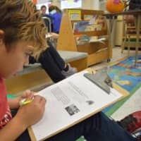 <p>A third-grader at Bronxville Elementary School works out a math problem using the Singapore Math technique. </p>