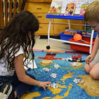 <p>Two third-graders at Bronxville Elementary School collaborate on solving a math problem using a visual hands-on approach they learned from the Singapore Math technique.</p>