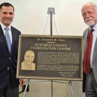 <p>Dutchess County Executive Marcus J. Molinaro, left, and Dr. Kenneth M. Glatt, former county commissioner of mental hygiene, unveil a plaque honoring Glatt at the county&#x27;s new stabilization center.</p>