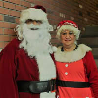 <p>Mr. and Mrs. Claus pose for a photo before the Candy Cane Run.</p>