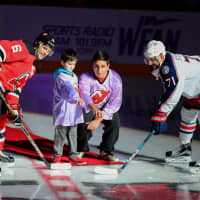 <p>Devils Capt. Andy Greene and Blue Jackets Capt. Nick Foligno are joined by 7-year-old Quinn Knapp of Cranford and 17-year old Alex Walsh of Fair Lawn for a ceremonial puck drop at the home team’s Hockey Fights Cancer night.</p>
