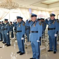 <p>New Rochelle officers salute in honor of those who lost their lives in the line of duty. The police department recently held ceremonies that also recognized the accomplishments of nearly 100 of its members.</p>