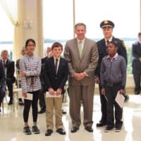 <p>New Rochelle City Manager Chuck B. Strome, center, handed out award for the top three Police Memorial essays to Natalie M. Chang, Justin Friedberg, and Stephen Philippeav. With them is Capt. Robert Gazzola.</p>