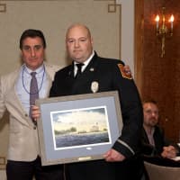 <p>Vincent Schitano, Norwalk Seaport Association president, presents the Beacon Award to Lt. Pirro at the recent gala.</p>